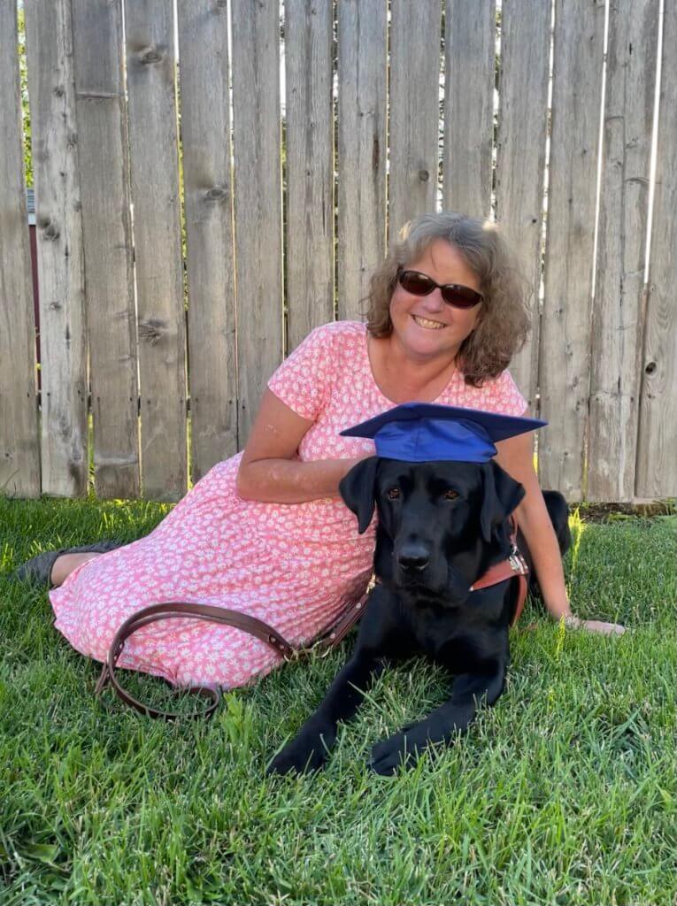 Graduate Carmen and black Lab guide dog Tommy