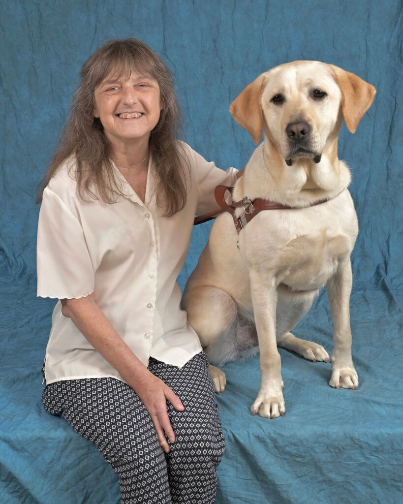 Graduate Janet and yellow Lab guide Theodore