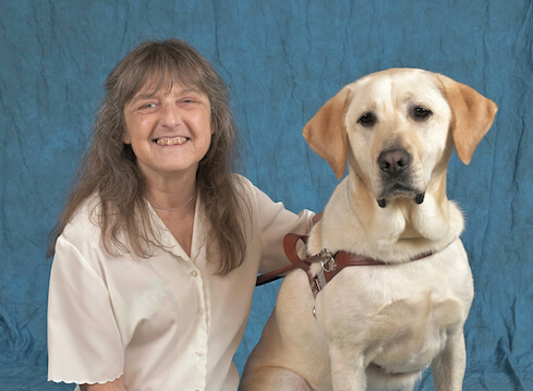 Graduate Janet and yellow Lab guide Theodore