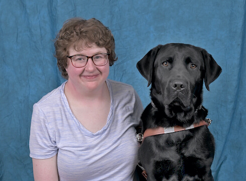 Graduate Jessica and black Lab guide dog Cameron