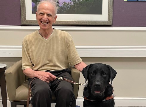 Graduate Ralph and black Lab guide dog Cannon