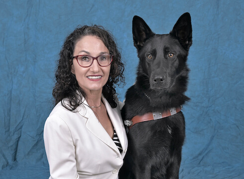 Graduate Nicole and black German Shepherd guide dog Hedwig