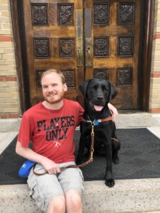 Graduate Justin and black Lab guide dog Ursula