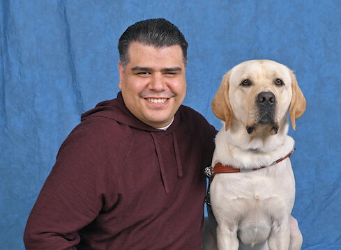 Graduate Jose Sebastian and yellow Lab guide dog Ulysses