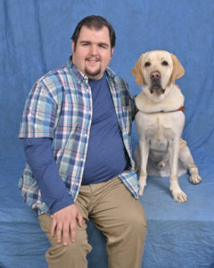 Graduate Richard with yellow Lab guide dog Scooter