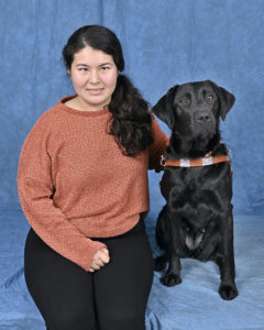 Grad Justine and black Lab guide dog Iris