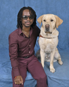 Grad Melchion and yellow Lab guide dog Larson