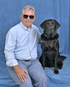 Graduate Tom and black Lab  guide dog Oscar