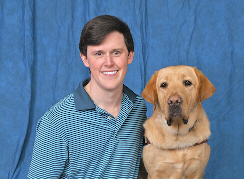 Alexander and yellow Lab guide dog Ballou