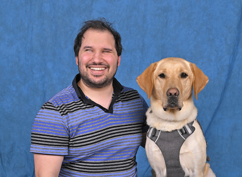 Daniel and yellow lab guide Lancelot in their portrait
