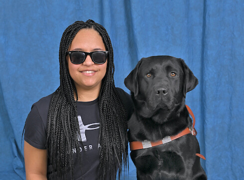 Darien and black lab guide Elvis in their portrait
