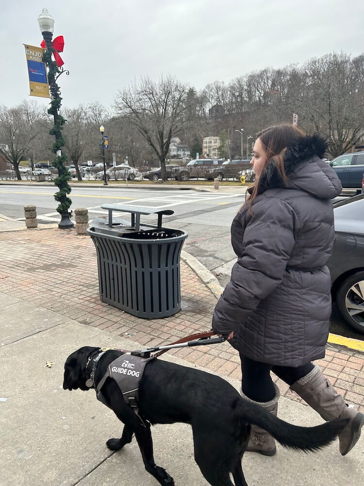 Harmony leads Apryl down a wide paved area