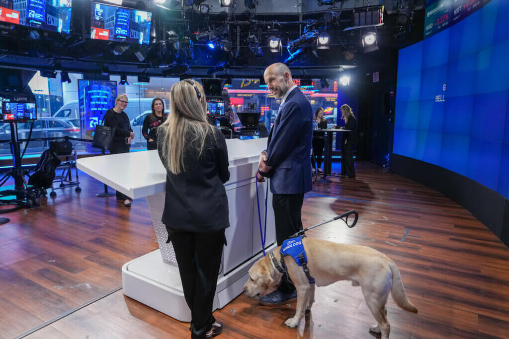 Thomas and Blaze at Nasdaq podium speaking to broadcast staff