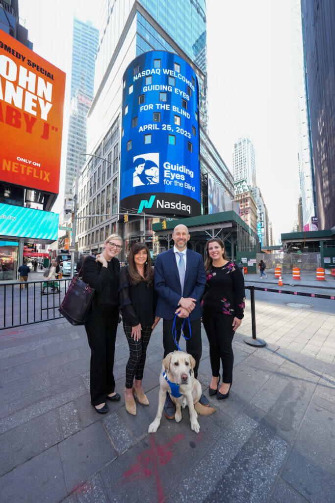 posed at the NASDAQ Jumbotron in Times Square