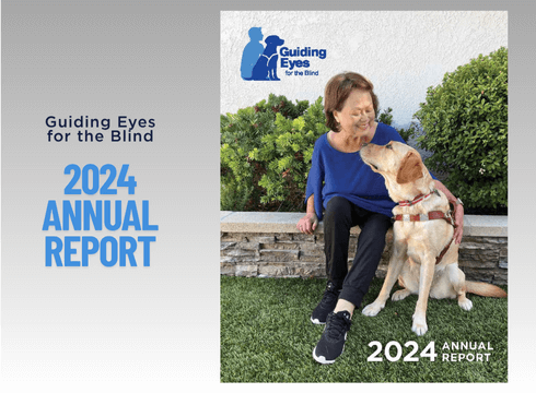 Annual Report 2024 Cover -A smiling woman sits on a low stone wall with bright green bushes behind her. Yellow Lab guide dog in harness sits at her feet as they look lovingly at each other displaying a strong partnership. 2024 Annual Report written in bottom right corner and Guiding Eyes logo is top left