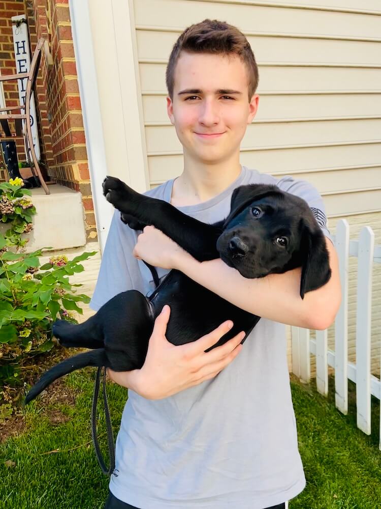 Raiser Gavin holds puppy Guthrie