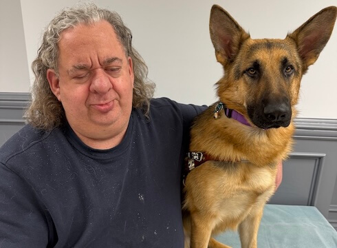 Matthew and German Shepherd guide dog Usher, sit side by side for their team portrait