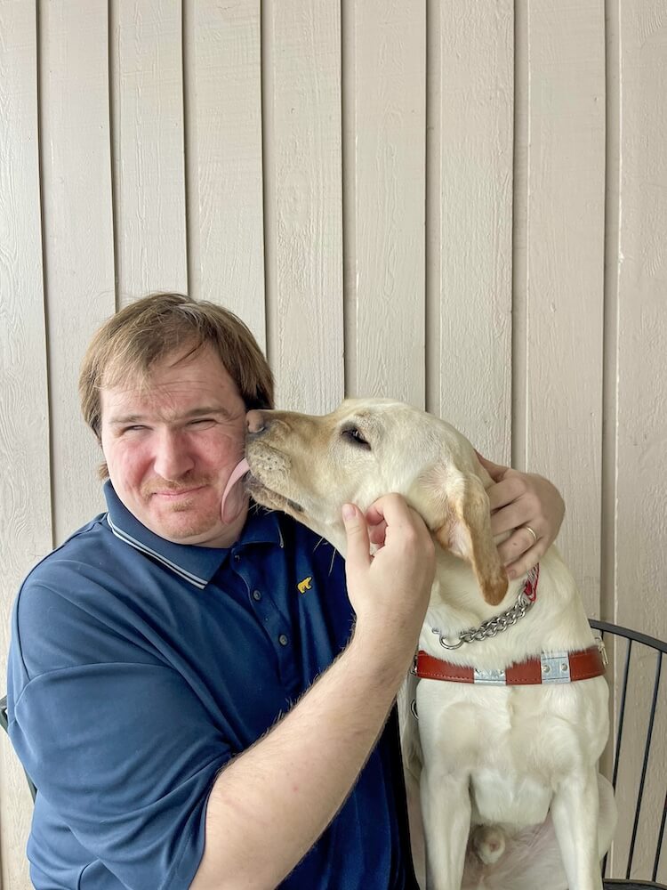Guide dog Norris gives handler Tony an unexpected kiss
