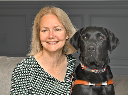 Barbara and black lab guide Kenneth in team portrait