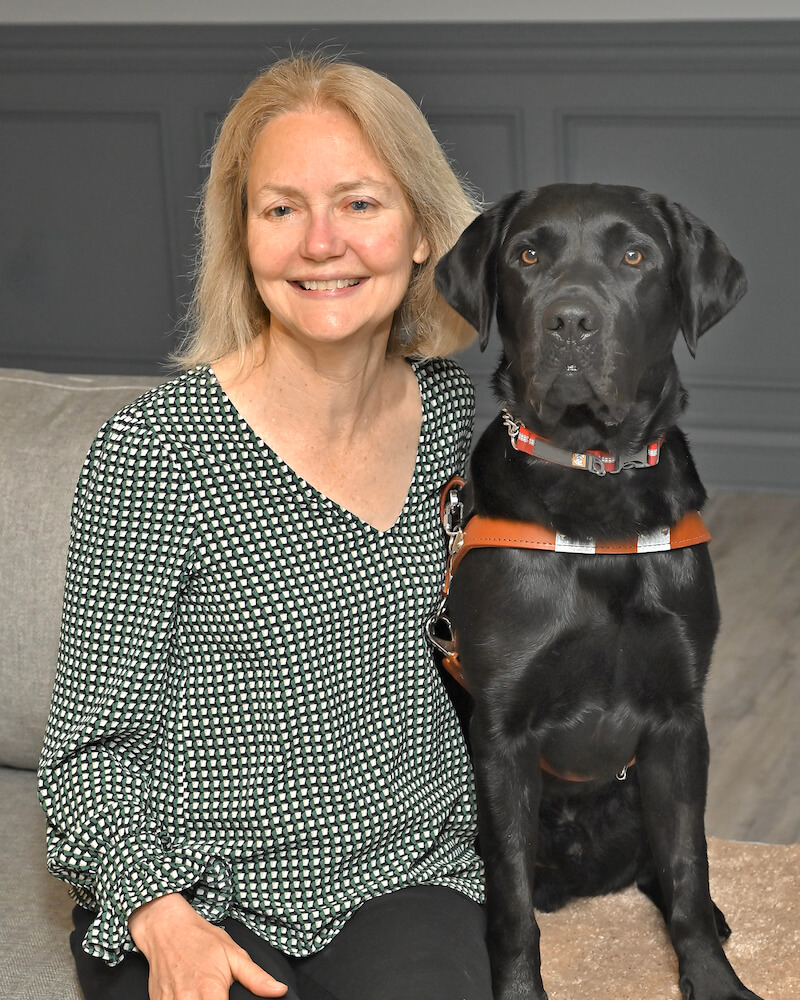 Barbara and black lab guide Kenneth in team portrait