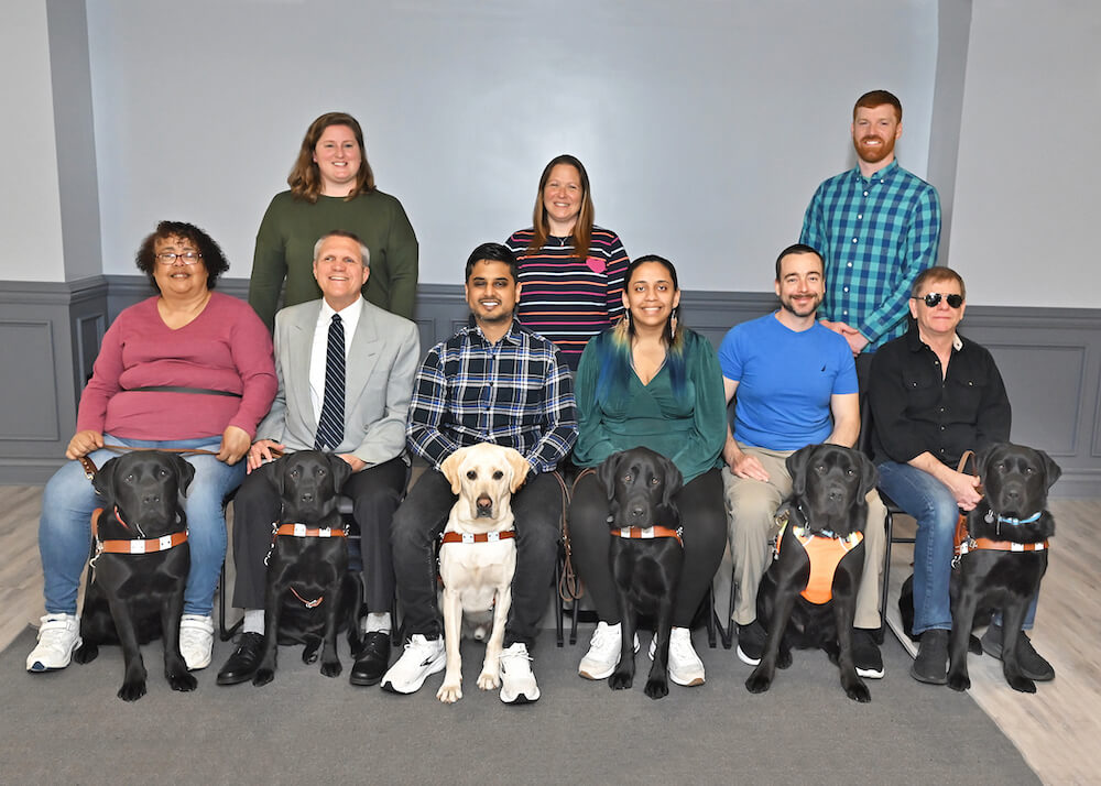 May 1 2023 class sits with dogs and instructors for class photo