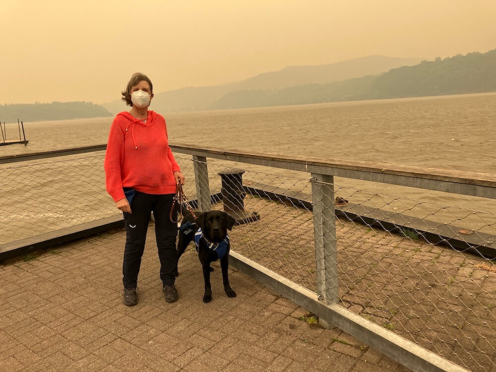 Megan (masked) and guide Fulton in Cold Spring NY amidst smoky haze of Canadian fires