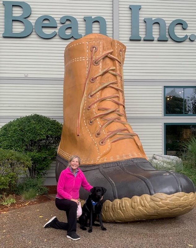 raiser Anne and Neptune pose with the giant LLBean boot in Maine