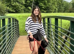 Catherine, breeding dog foster with stud dog Ralphie on a bridge