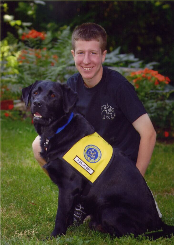 Dan Oonk with Pongo, GEB released dog with therapy vest