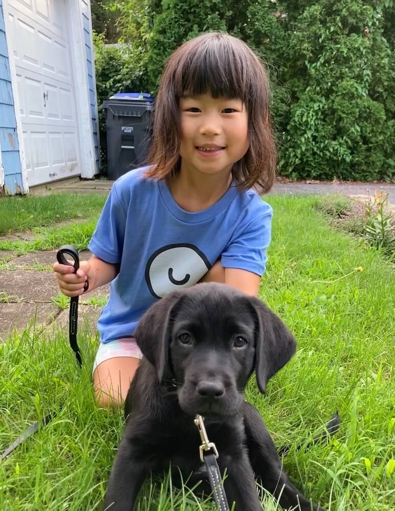 puppy on program Reina in a down with child