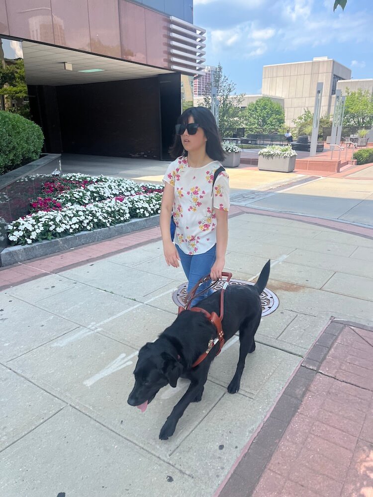 Florie leads Phuong down a sidewalk of varying surfaces