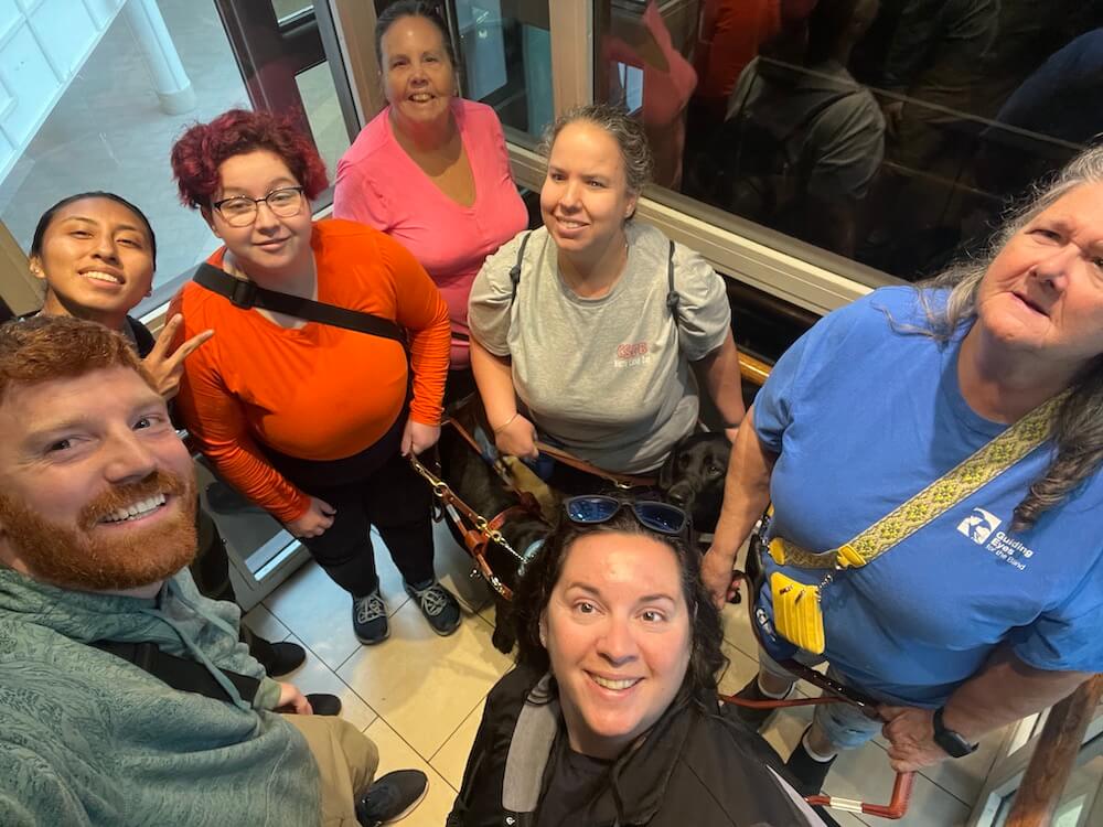 an informal selfie of trainers and Aug 14 2023 class looking up