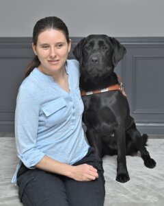 Candice sits next to back Lab guide Charlotte for their graduate team photo