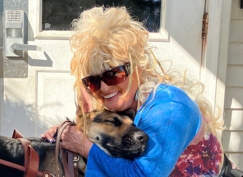 Deborrah and her German Shepherd guide Dixie share a loving hug after a training walk