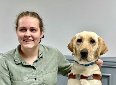 Franny and yellow Lab guide dog Yolanda sit for their team portrait