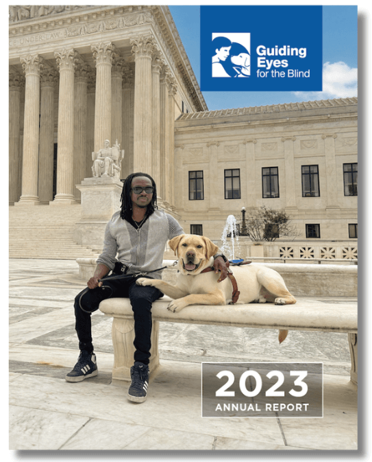 2023 Annual Report- Melchion sits on the stone bench at the plaza outside the United States Supreme Court in Washington DC. Larson, a male yellow Labrador retriever, lies in a down position on the bench beside him. Larson has a happy expression as he looks toward the camera, and rests a paw on Melchion's leg. The Supreme Court building in the background has tall columns with steps leading up to the entrance.