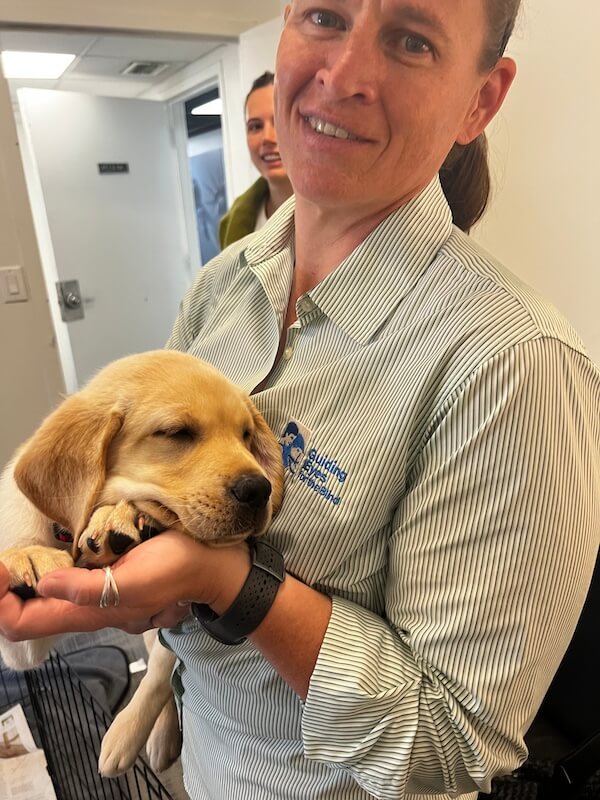 Behind the scenes - Jolene holds one of the puppies backstage