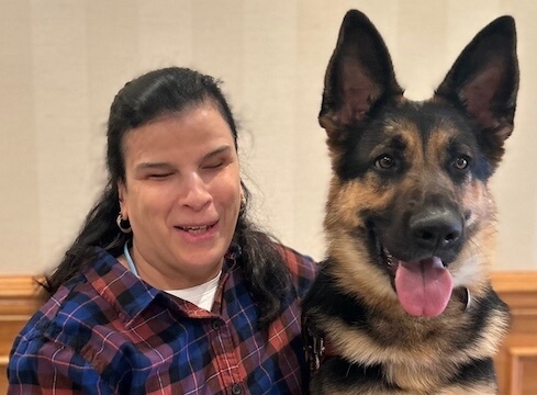 Gladys and German Shepherd guide dog Whitney sit side by side for their team portrait