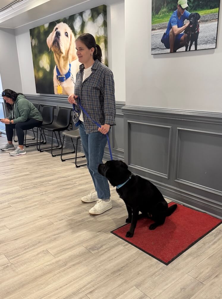 Maddie and Jacki both stand in their spots waiting for instruction in Alumni Hall during training
