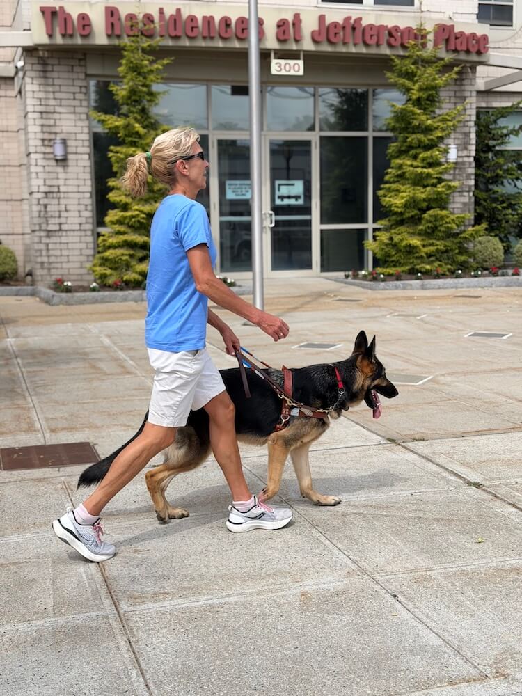 From their right, Katie and Steinway are seen walking quickly & confidently past a building entrance
