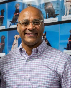 Chris Perry closeup against backdrop of Breeding Dog photo wall in Patterson