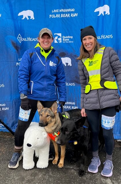 Jolene with Rhiana, a dog in harness training, and Rookie, a stud, and Elena