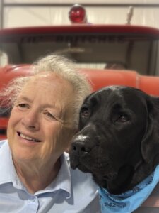 In a close up Oleta and her guide dog Robbie, a female black lab, are head to head