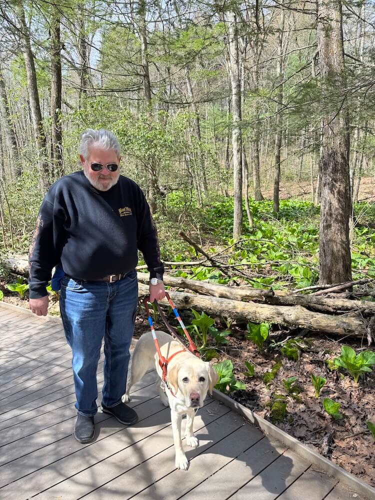 Abilene lead Paul safely down a wooden trail in the woods