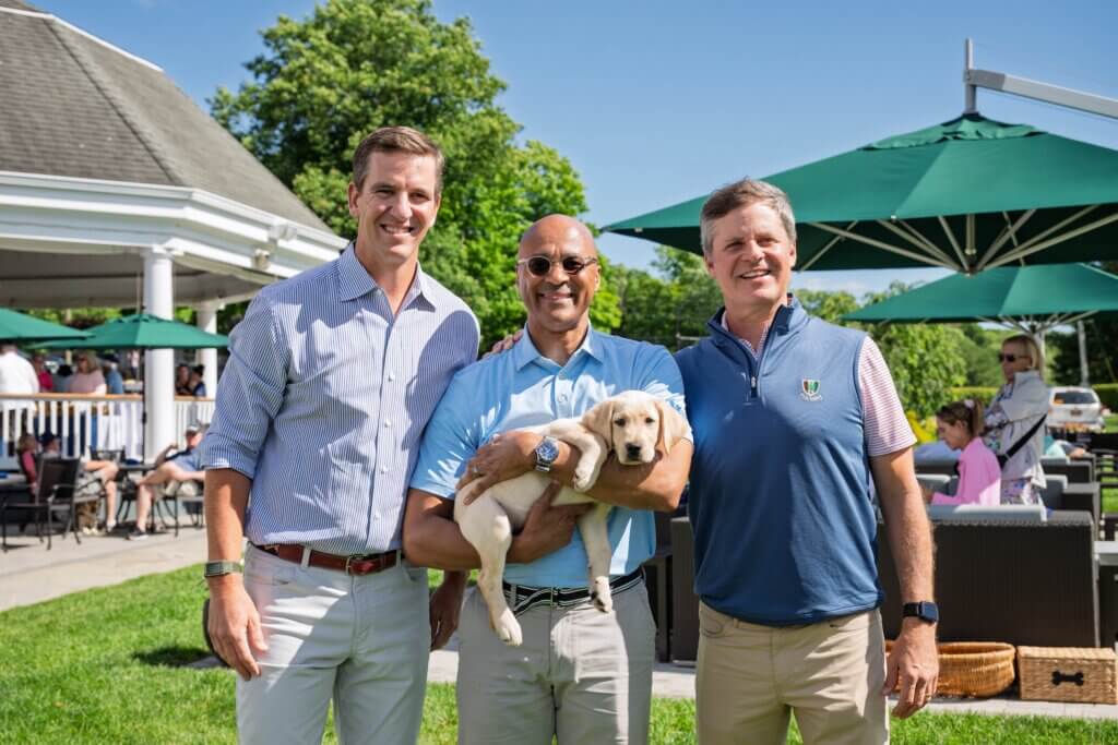 Eli, Chris holding Rodeo (male yellow lab puppy), Pat Browne III