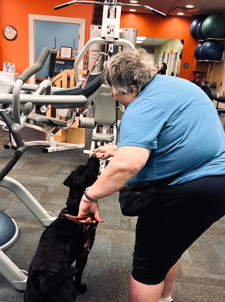 Katherine gives Morgan a treat as she introduces her to the physical therapy equipment