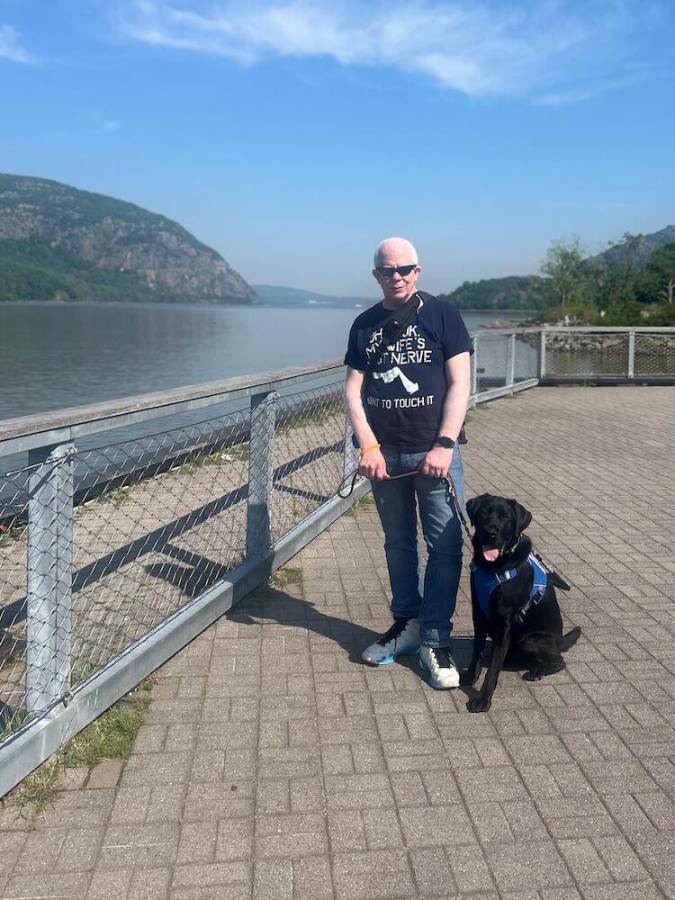Willie and Bono stand on the pier overlooking the Hudson River on a sunny day