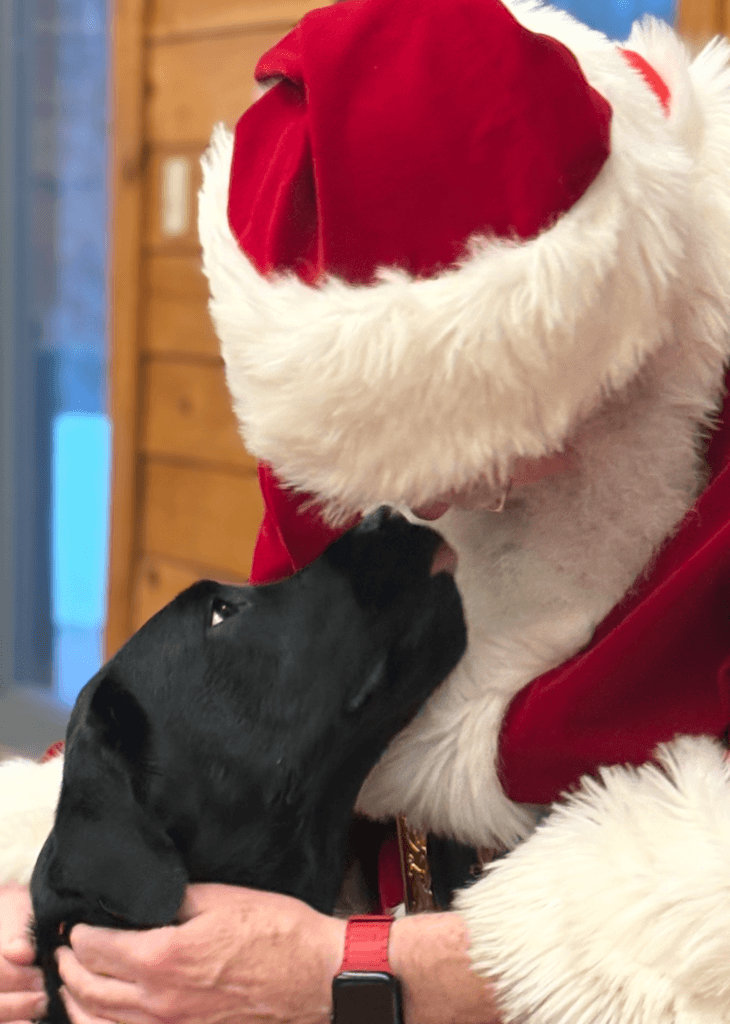 Pup Spunky looks up into Santa's face lovingly