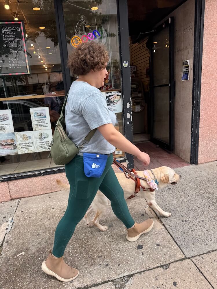 Franny and Tatum walk confidently down an urban street past storefronts